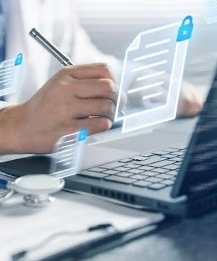 Doctor reviewing digital medical records on a laptop.
