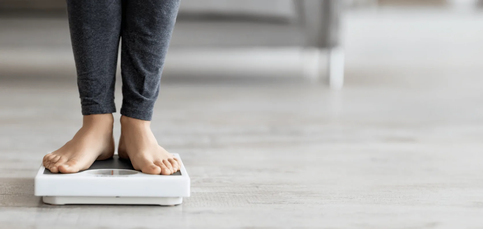 Stepping on a weighing scale.
